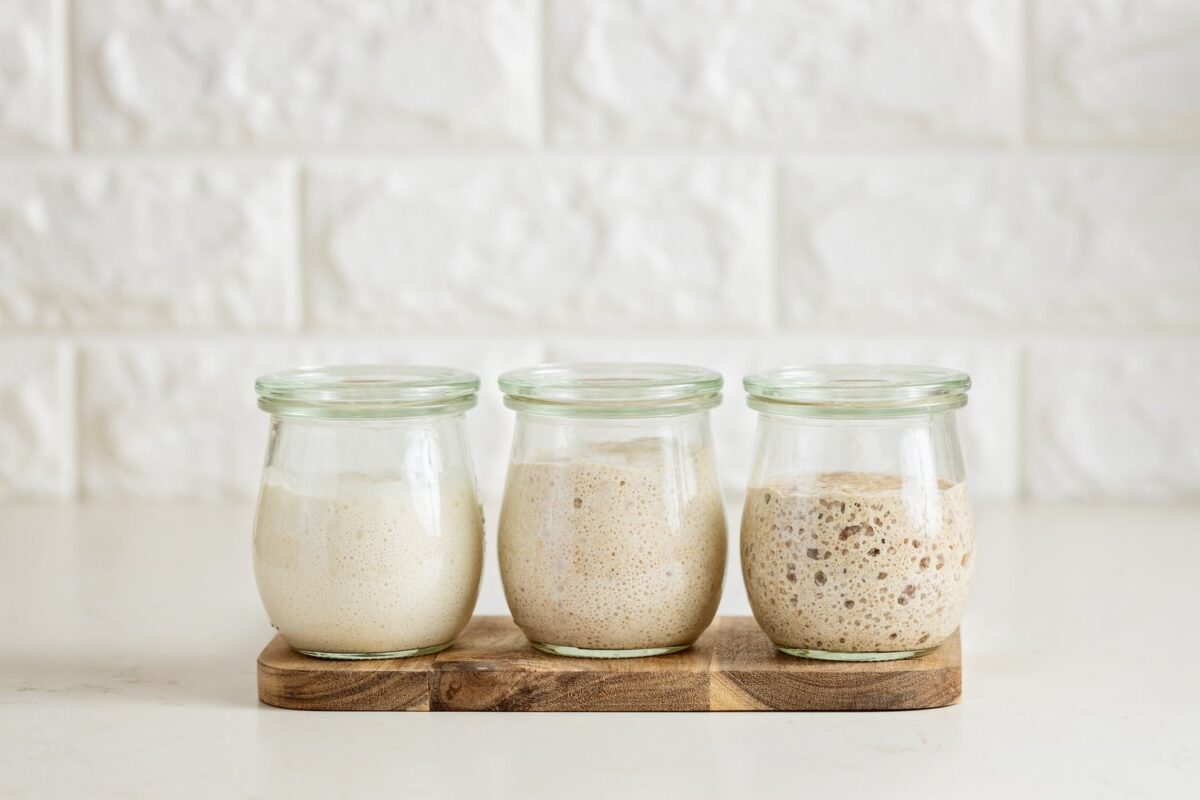 Three,Glass,Jars,With,Active,Sourdough,Starter.,Spelt,,Rye,,And