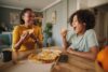 Mother,And,Teenage,Son,Having,Pizza,At,Home